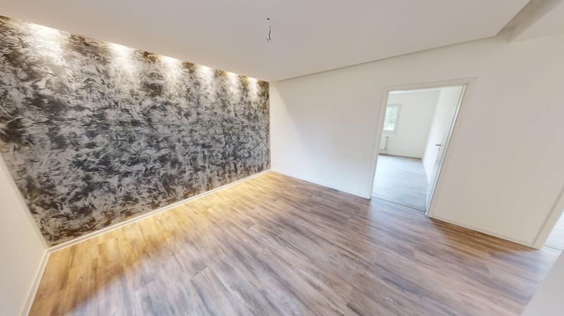 wooden floor, white walls, an artistic textured wall, an open door