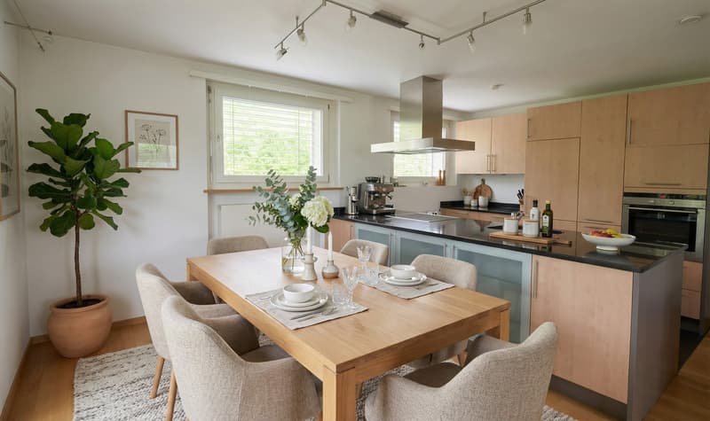 wooden dining table, beige chairs, flower vase, potted plant, wooden cabinet, modern kitchen, window, stainless steel range hood, coffee machine, kitchen appliances