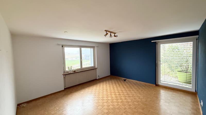 room, wooden floor, blue wall, white ceiling, window, radiator