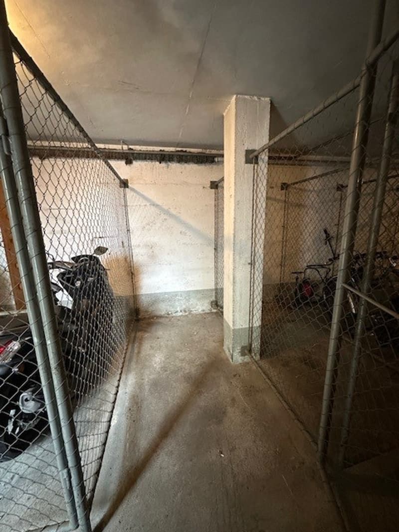 underground parking lot, motorcycles, fenced area