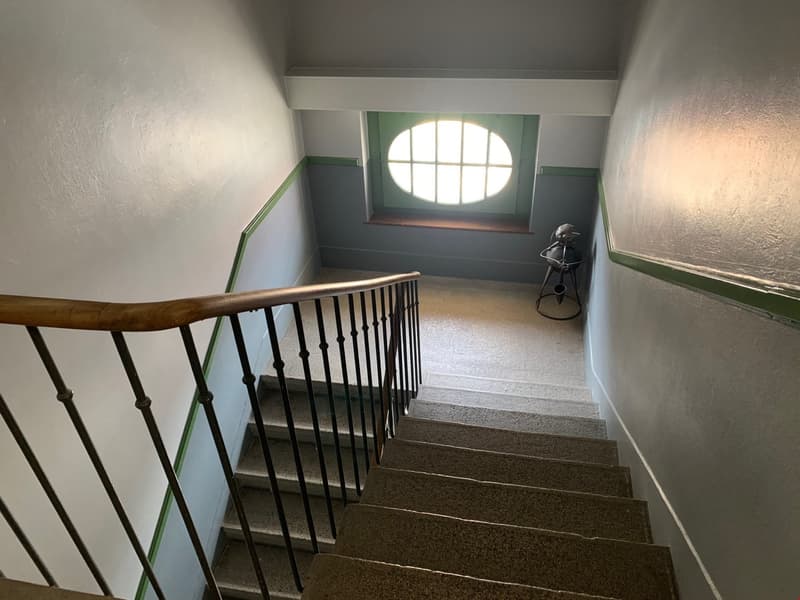 white and green walls, wooden handrail, metal handrail, arched window