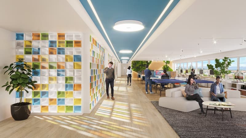 office building, indoor area, long hallway, people walking, sitting, and talking, bright lighting, wall, table tennis table, potted plants, carpeted floor, window