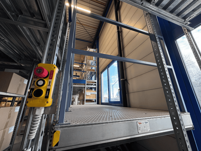 Industrial building with metal framing and raised ground floor.