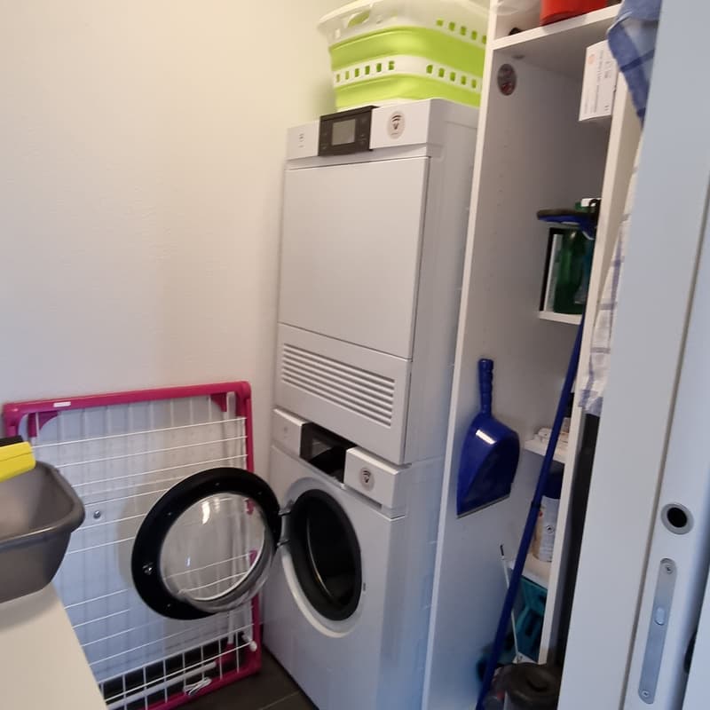 Laundry room with washer, dryer, sink, shelf, cleaning tools