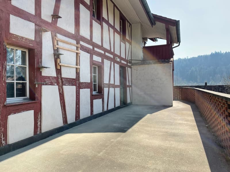wooden structure, white and red exterior, windows, balcony