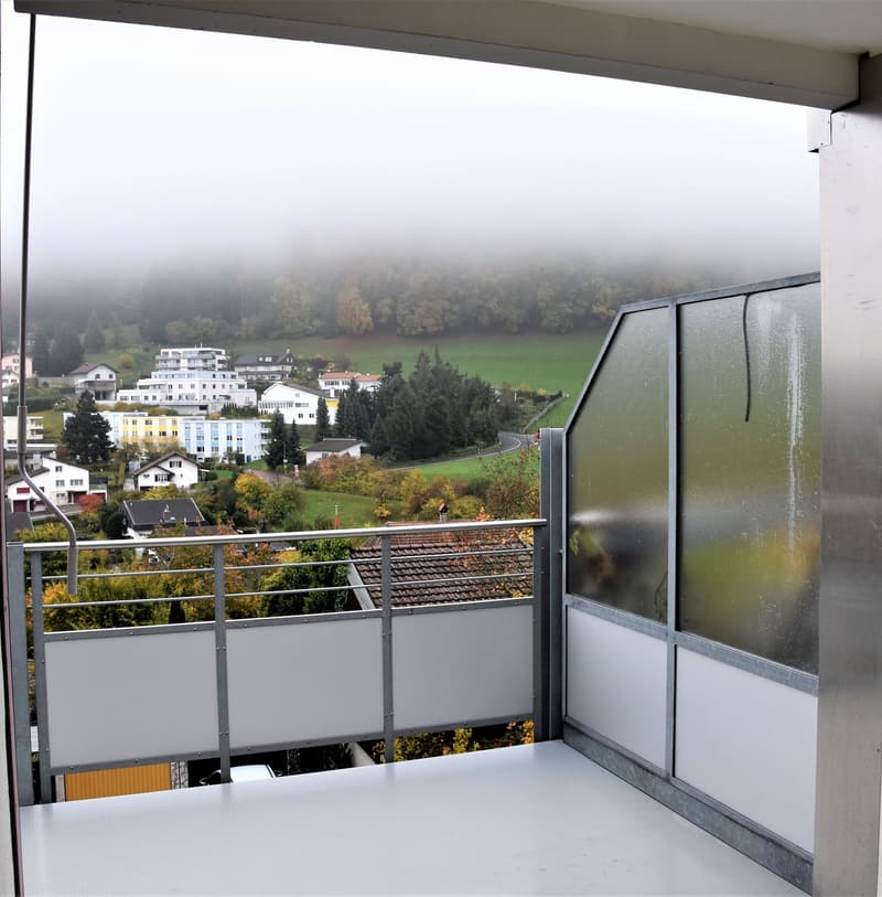 enclosed terrace with metal fencing, large panoramic window, views of town and landscape