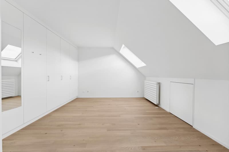 empty room, wooden floor, white walls, built-in wardrobes, two skylights