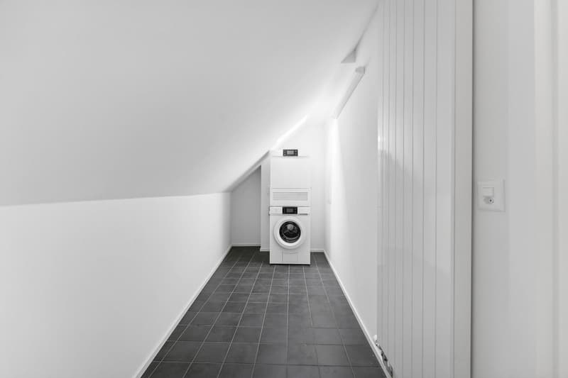 white tiled floor, white walls, white stacked washer-dryer set