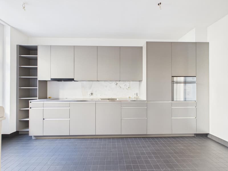 modern kitchen with gray cabinets, stainless steel countertop, built-in oven and dishwasher, tiled floor