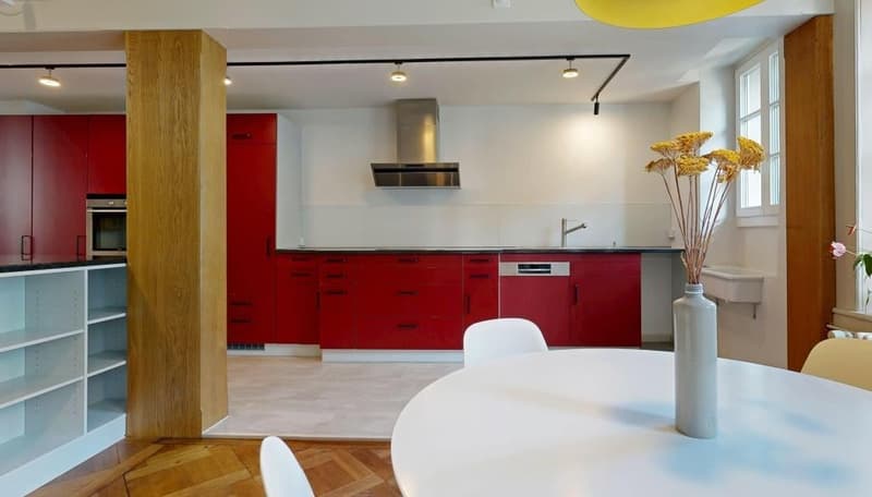 modern kitchen, red cabinets, white countertops, stainless steel appliances, white dining table, white chairs