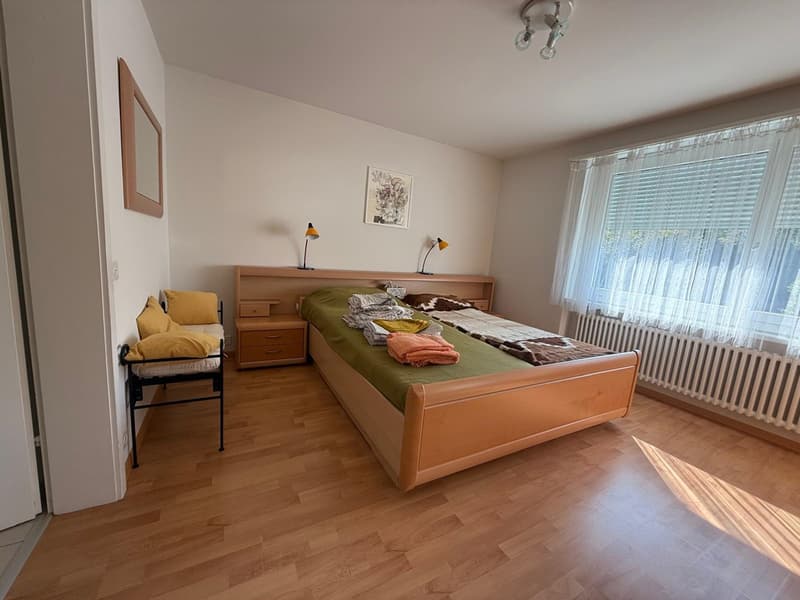 double bed, nightstands, lamps, radiator, curtained window, sofa bed, framed pictures