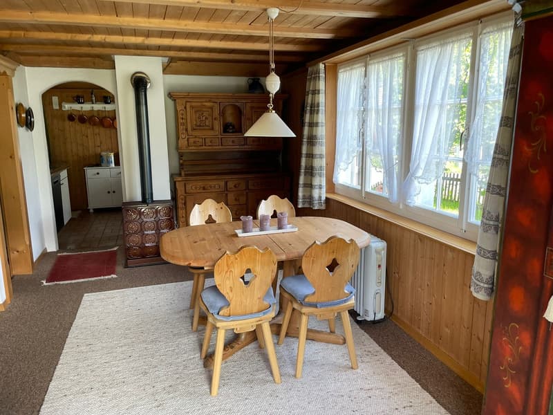 wooden table with 4 chairs, a wooden cabinet and chimney