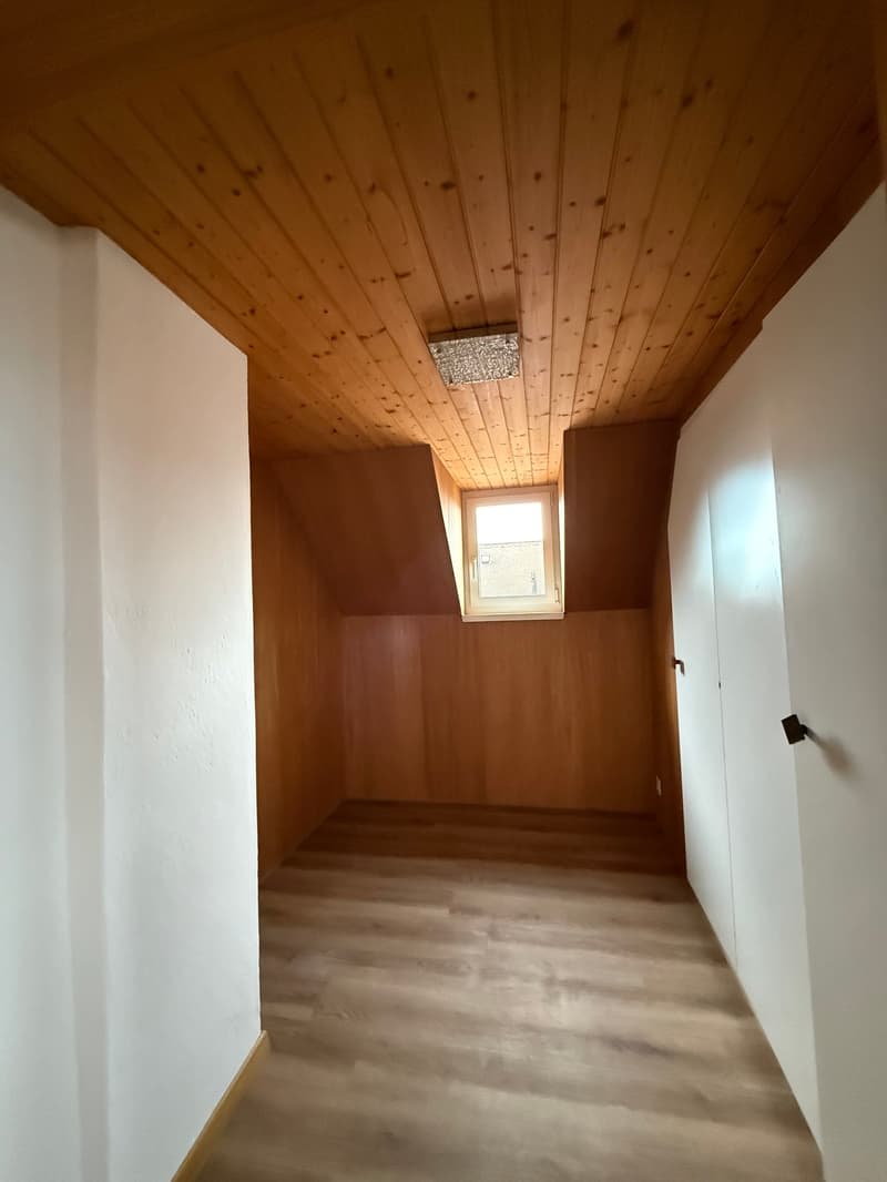 empty room, wooden ceiling, wooden floor, small window, white walls, built-in wardrobes