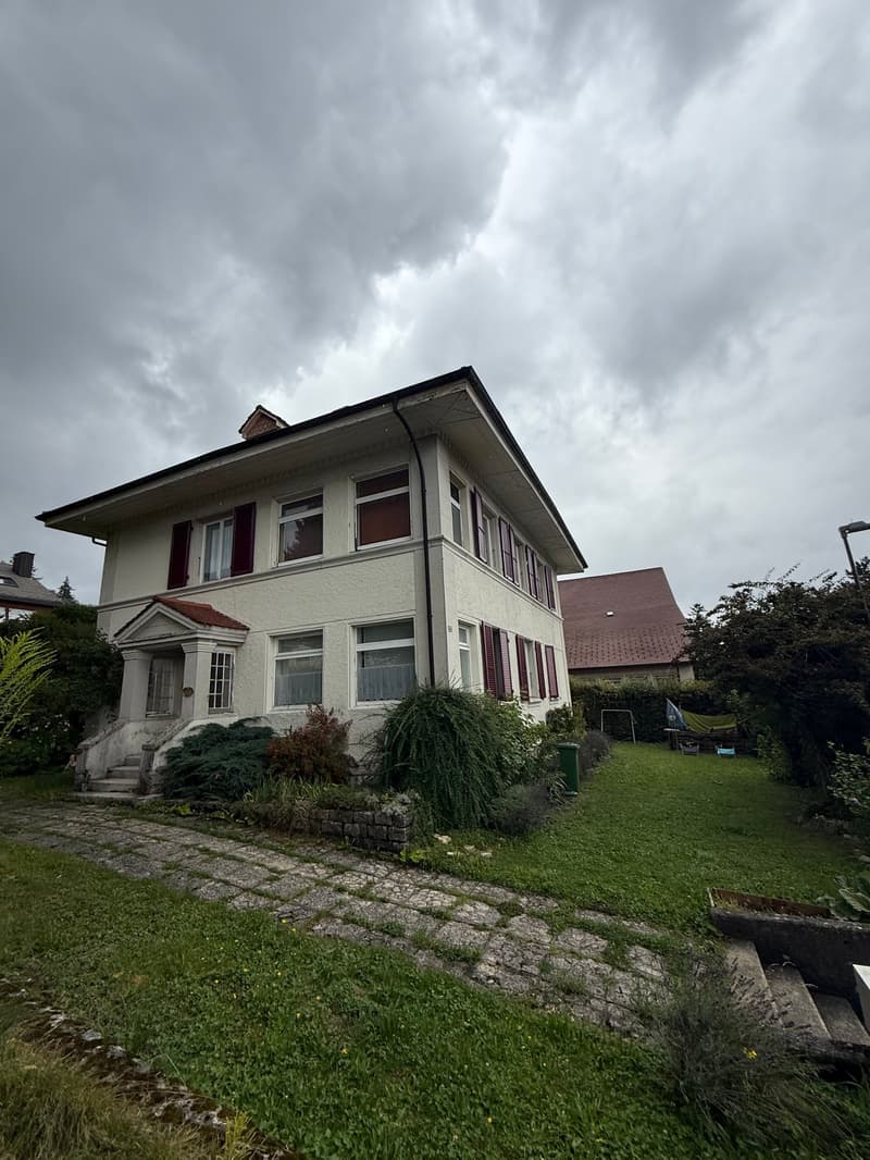 2 story house, white exterior, red shutters, brick pathway, garden, green lawn
