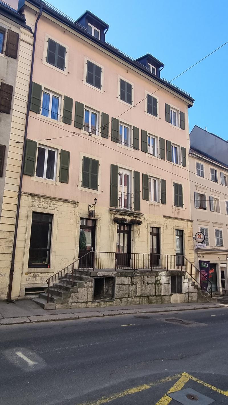 5 story building, beige facade, green shutters, raised ground floor, stairs leading to entrance