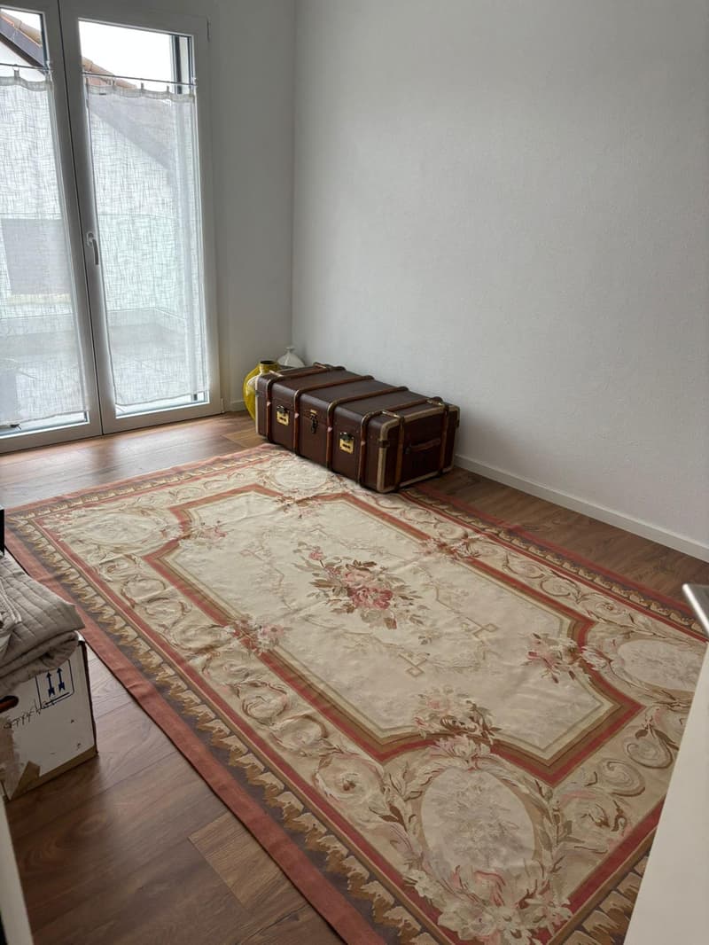 empty room, carpet, large window, glass door to balcony