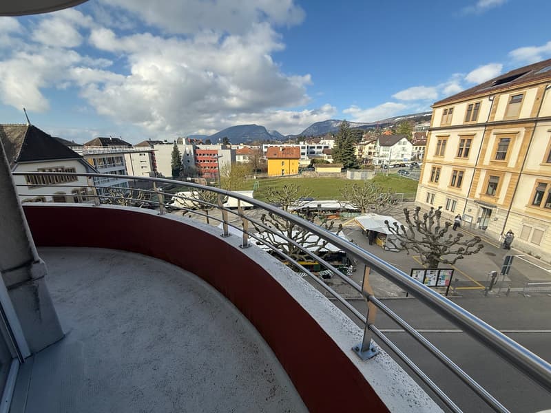 Balcony with metal railing, view of the city and mountains