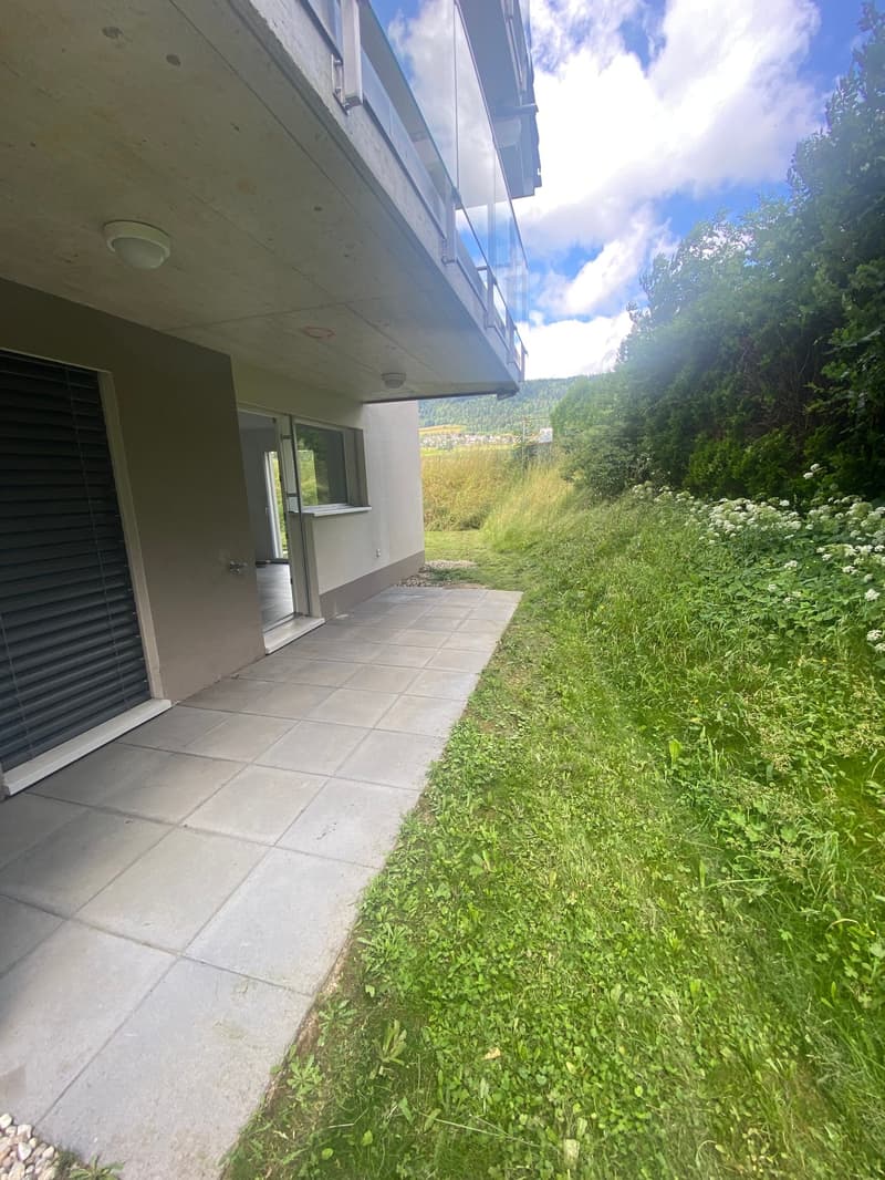 modern house, concrete balcony, glass windows, tiled entrance, grassy area