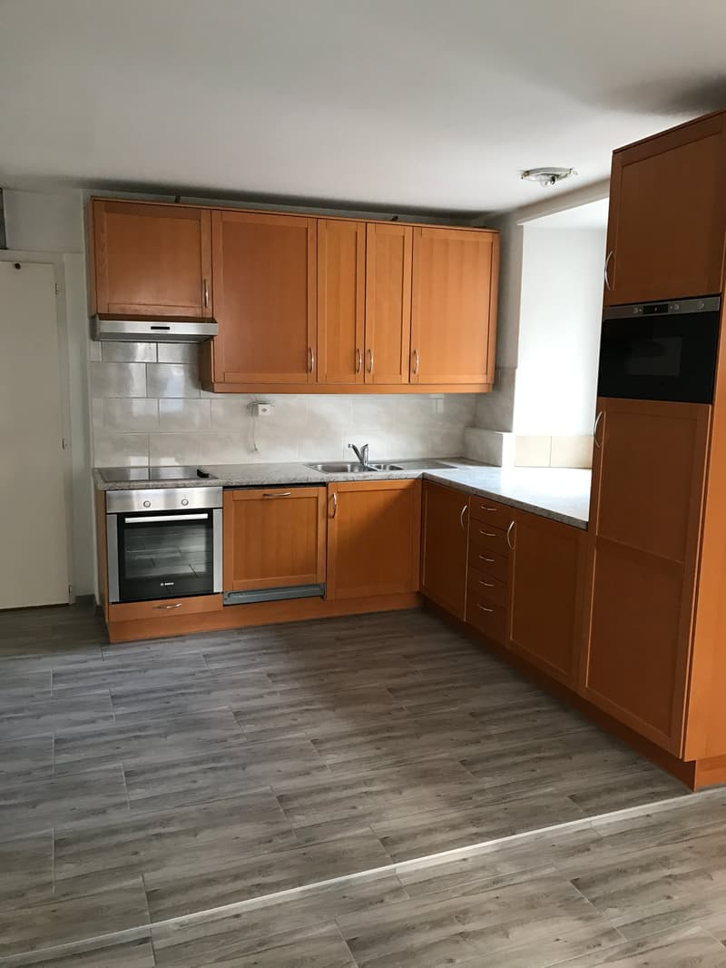 kitchen with wooden cabinets, granite countertop, stainless steel oven, sink, dishwasher