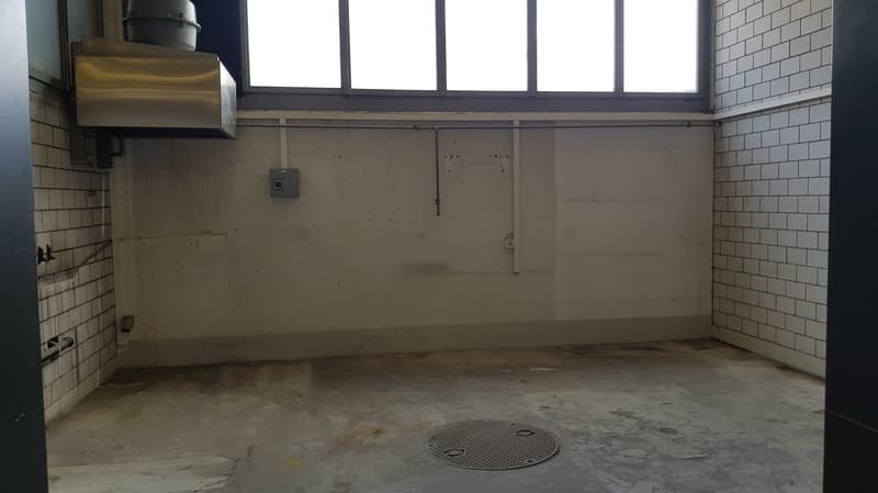 empty room, tiled walls, electrical outlet, small window, floor drain