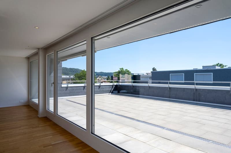 empty room, large glass doors, wooden floor, modern interior, terrace with stone floor and metal railing