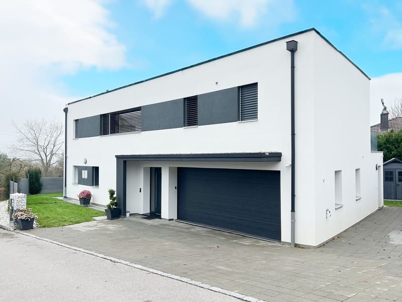 modern, white exterior, black and gray accents, large driveway, large garage