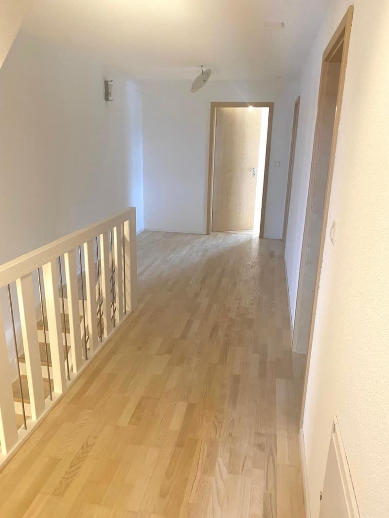 wooden floor, white walls, open doors, staircase, hallway