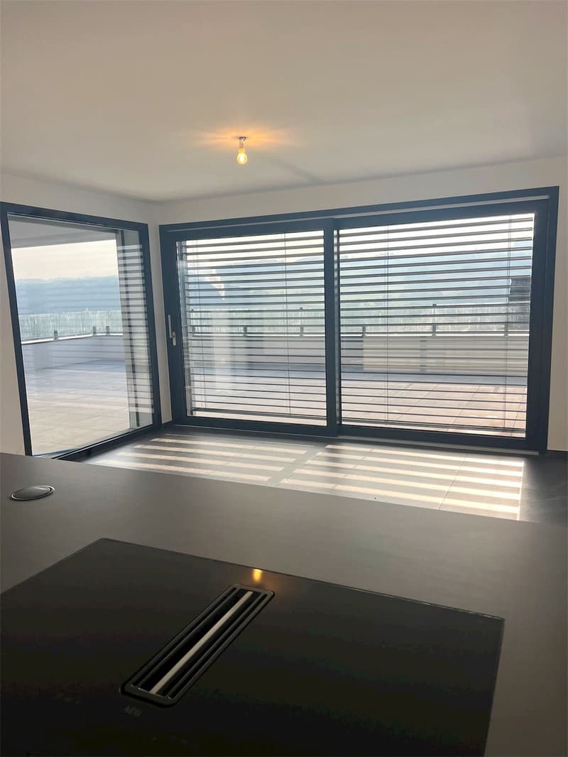 Empty room with large windows, tiled floor, modern design, balcony view