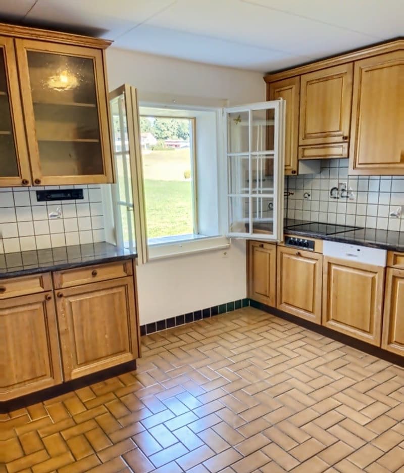 kitchen with wooden cabinets, tiled floor, open window, dishwasher