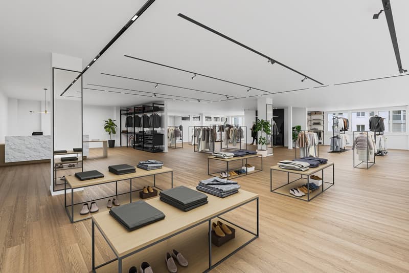 modern store with wooden floor, white walls, modern lighting, clothing displays, tables with folded clothes, shoes, and accessories