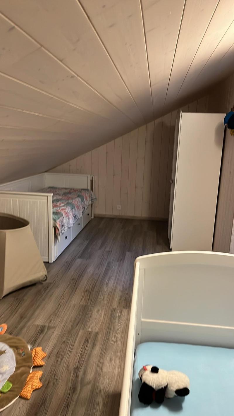 wooden floor, wooden wall, two white beds, closet