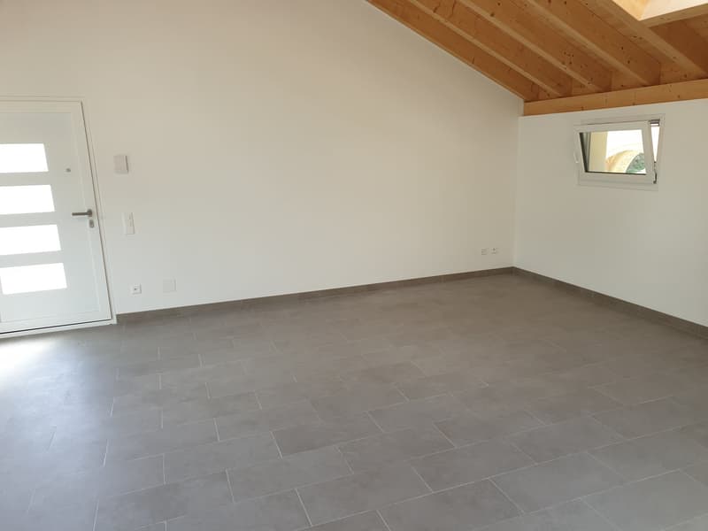 empty room with gray tiled floor, white walls, wooden ceiling, white door, small window
