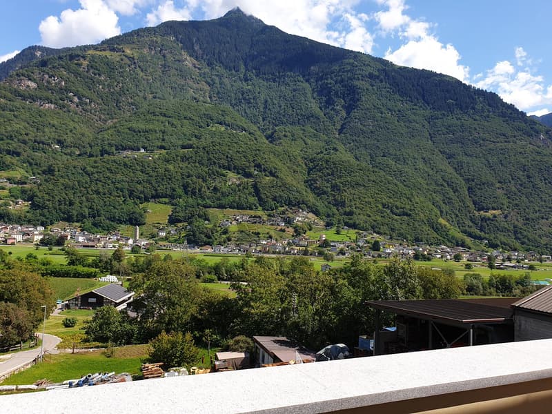 aerial view of mountain valley with a house in the foreground