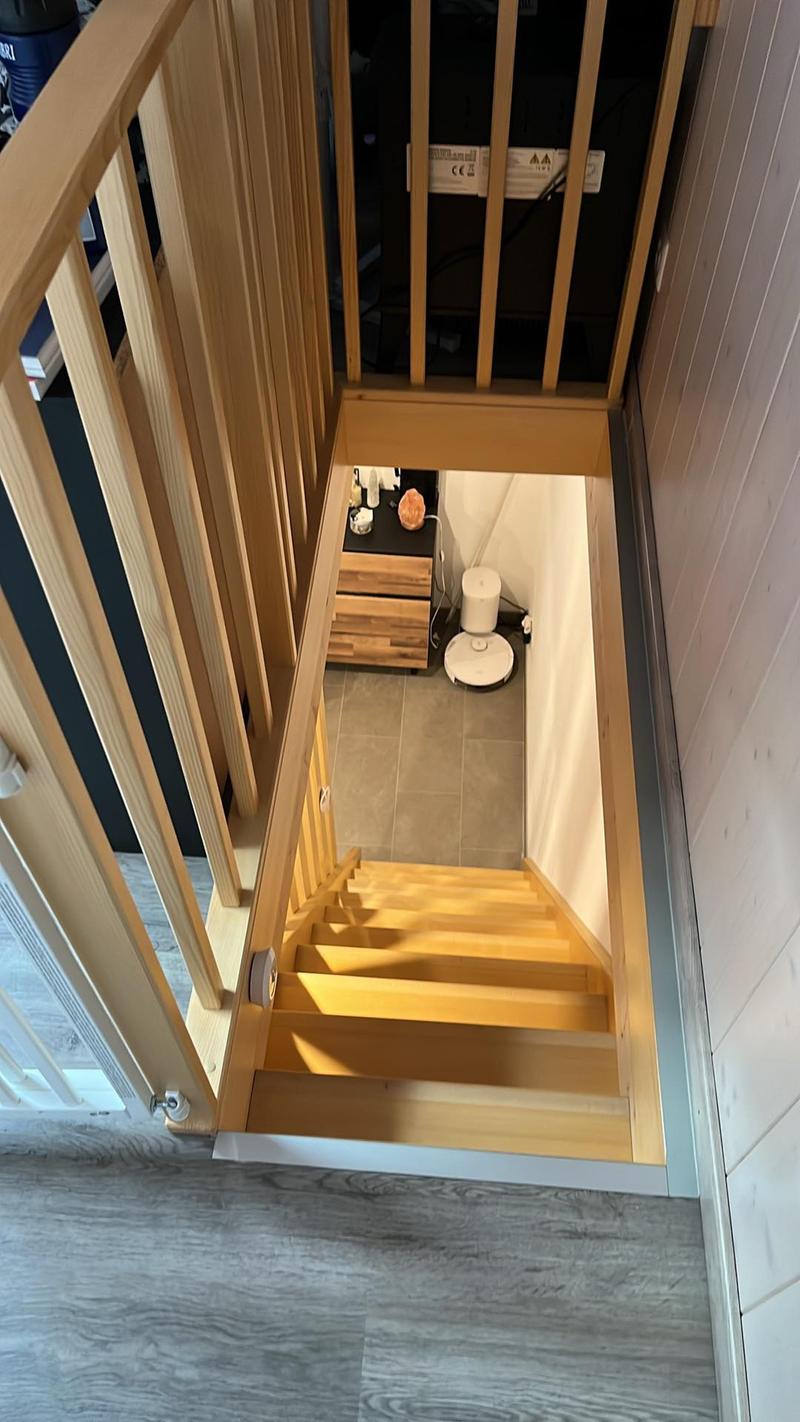 Wooden staircase with handrail, a small room underneath