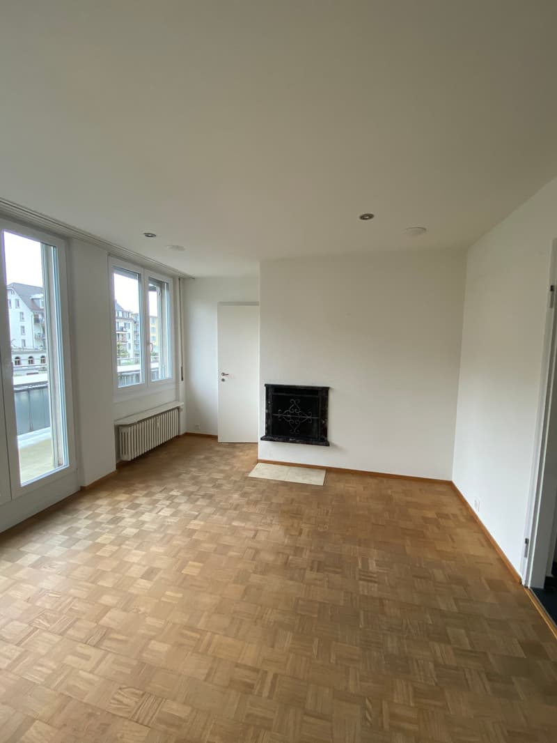 empty room, wooden floor, white walls, fireplace, windows, sliding doors