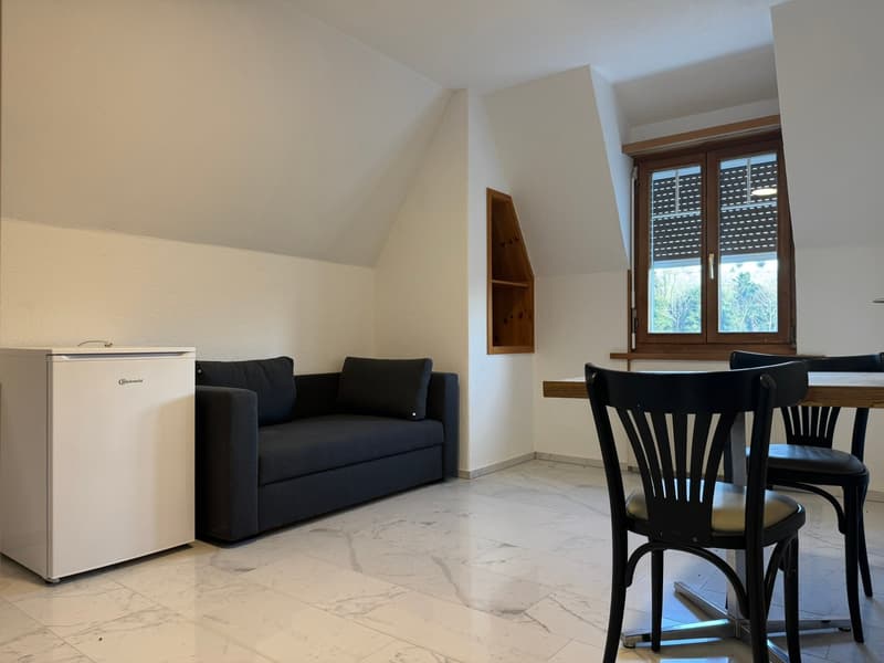 White wall, white marble floor, a sofa, a mini-fridge, wooden table, 3 chairs, a window with blinds