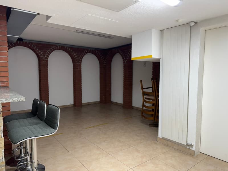 empty room, tiled floor, brick pillars, chairs, door, arch doorways, lights