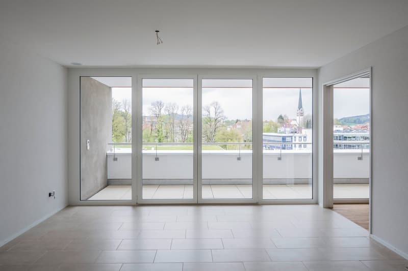 empty room, large sliding glass doors, balcony, tiled floor, white walls