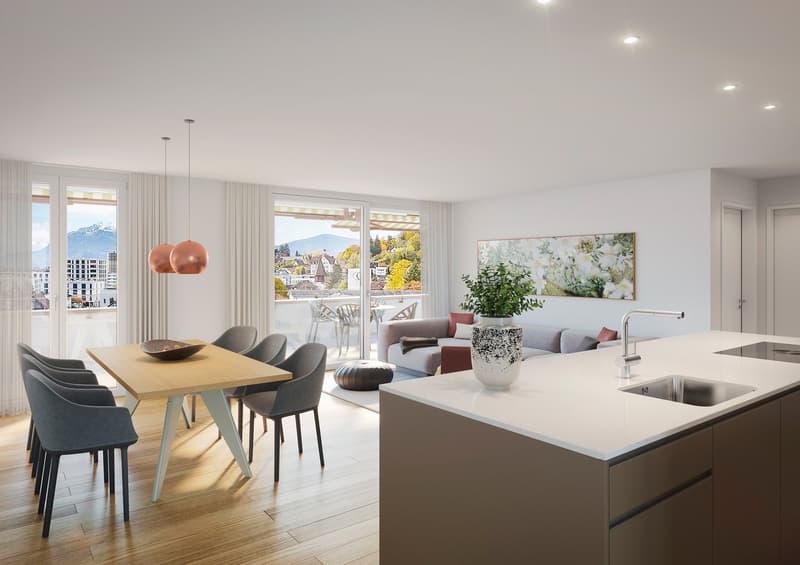 Dining area with wooden table, chairs, and a view of the mountains. Open kitchen with a countertop, sink, and faucet. Living area with a couch, ottoman, and a painting on the wall. Balcony with a table and chairs.