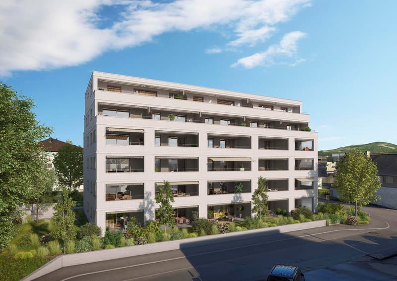 Modern apartment building with multiple floors, balconies, and greenery
