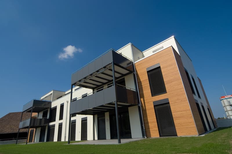 modern design, multiple balconies, white and brown exterior, large windows, flat roof