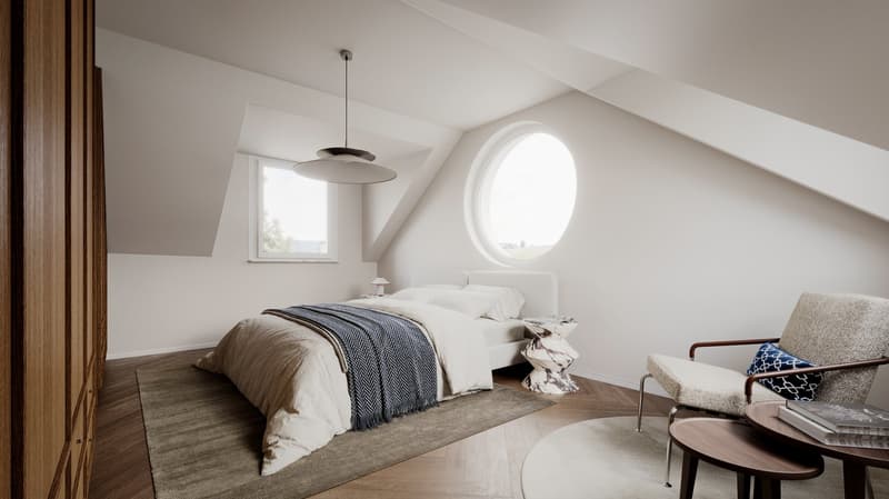 bedroom with bed, rug, chair, table, lamp, round window, circular ceiling lamp