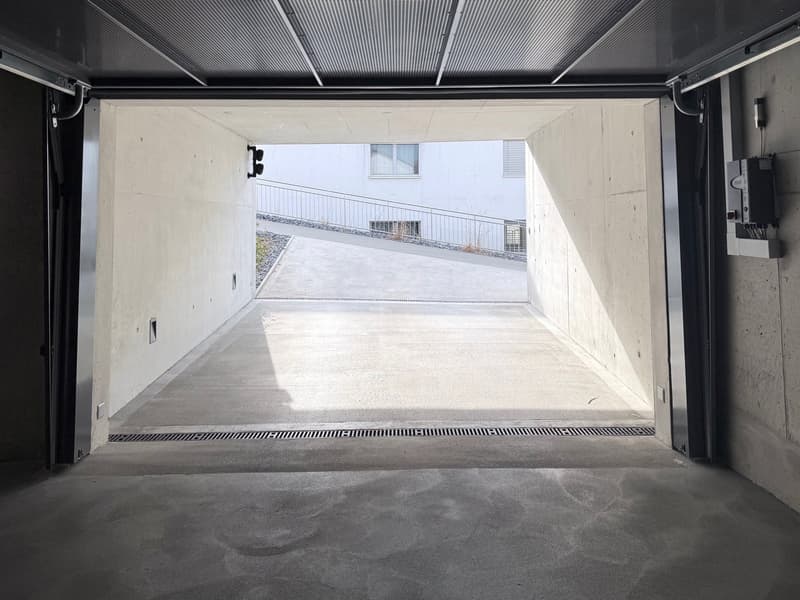 open concrete garage entrance, underground parking, white ceiling
