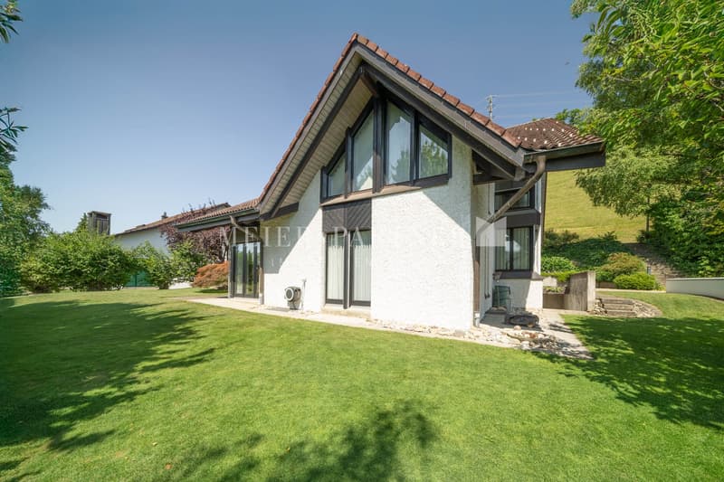 Detached house, single-family home, brown tiled roof, white exterior, large windows, garage, lush garden, outdoor seating area