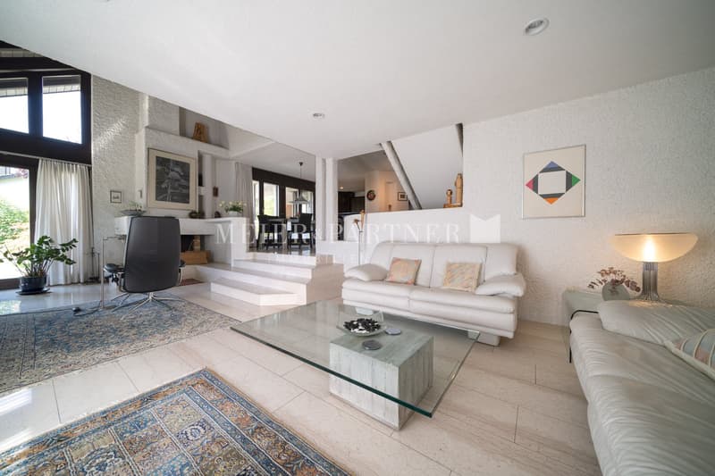 large open space, white sofas, glass coffee table, hardwood floors, decorative lamps, staircases