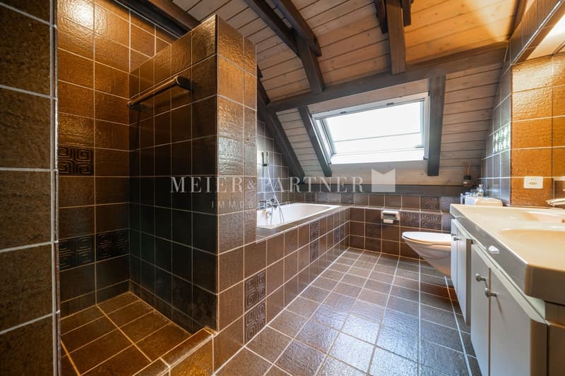 Bathroom with bathtub, toilet, sink, wooden beams, tiled floor, shower, skylight