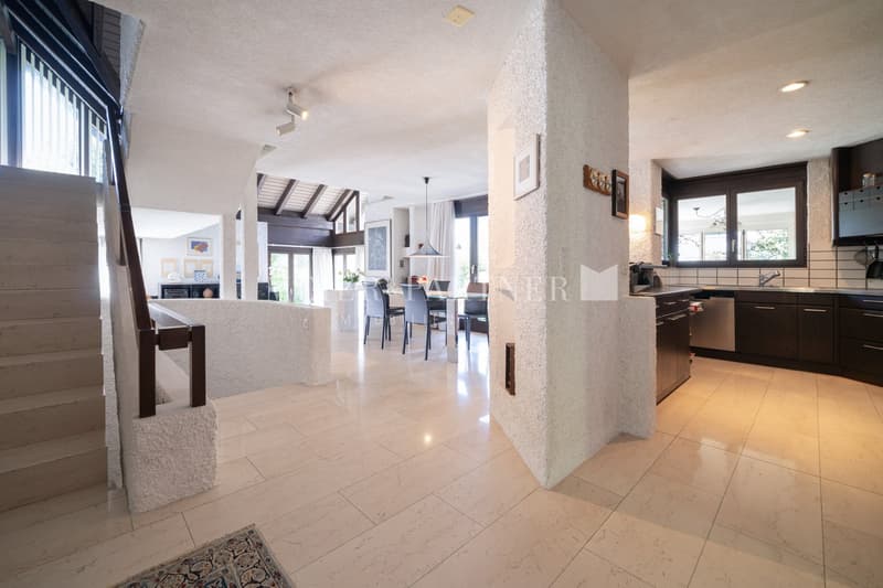 open space with living room, kitchen, dining area, and stairs leading to upper floor