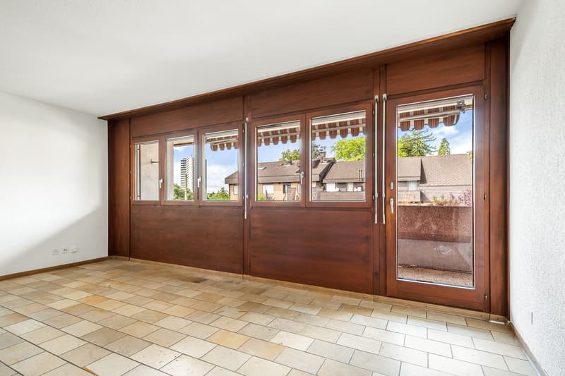 Large balcony, large windows with balcony, tiled floor, wall-mounted power outlets, wooden door with sliding glass panels