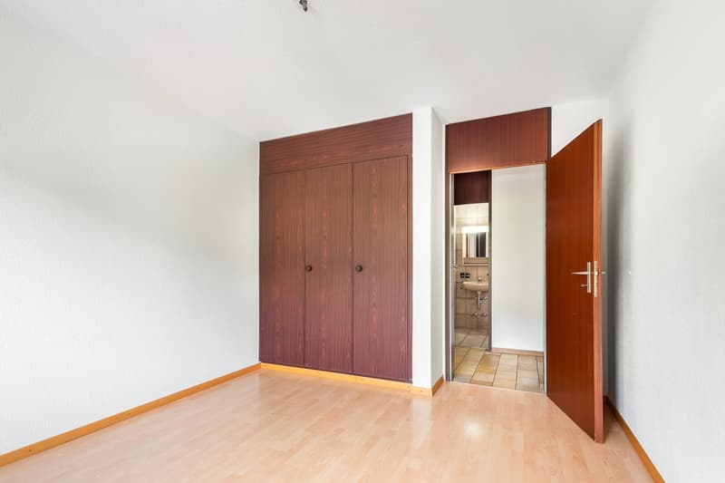 large wooden closet, tiled shower room, wooden floor