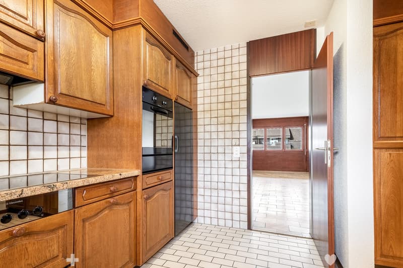 white tiles, wooden cabinets, black appliances, granite countertop, stove with glass door